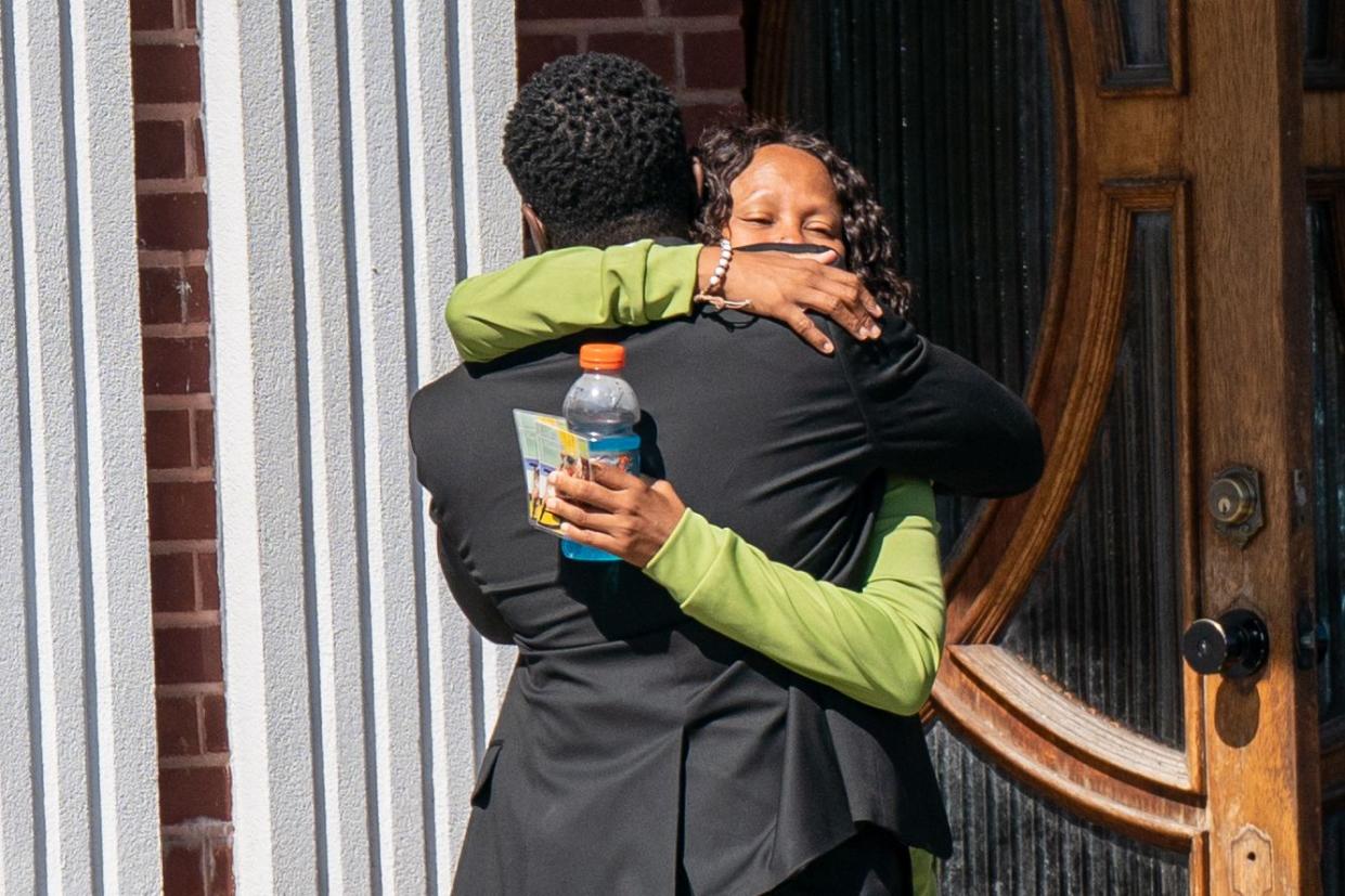 Mourners hug outside the Caribe Funeral Home on Utica Avenue in Brooklyn on Thursday. 