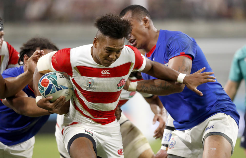 Japan's Kotaro Matsushima runs at that Samoan defense during the Rugby World Cup Pool A game at City of Toyota Stadium between Japan and Samoa in Tokyo City, Japan, Saturday, Oct. 5, 2019. (AP Photo/Shuji Kajiyama)