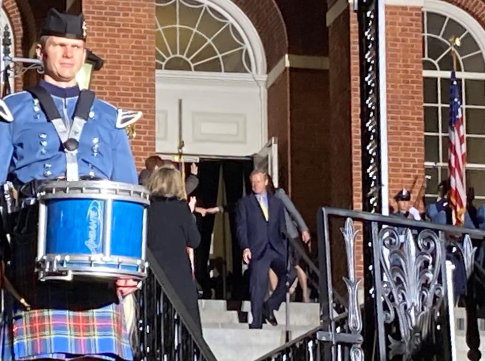 Gov. Charlie Baker walks out the Statehouse to applause, music and a 19-gun salute.