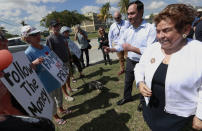 Rep. Joaquin Castro, D-Texas, second from right, Chairman of the Congressional Hispanic Caucus, and Rep. Donna Shalala, right, chat with demonstrators after their tour the Homestead Temporary Shelter for Unaccompanied Children, Tuesday, Feb. 19, 2019, in Homestead, Fla. (AP Photo/Wilfredo Lee)