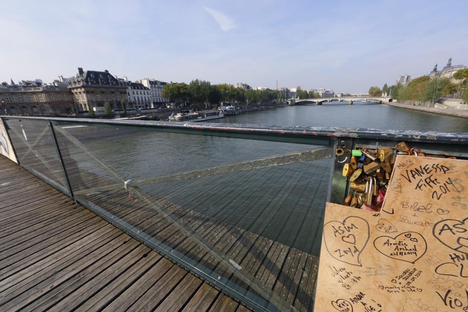 Two plastic panels protect the metal fence of the Pont des Arts over the River Seine in Paris September 23, 2014. (REUTERS/Jacky Naegelen)