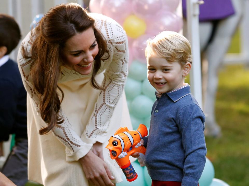 Prince George plays with a bubble gun in 2016.