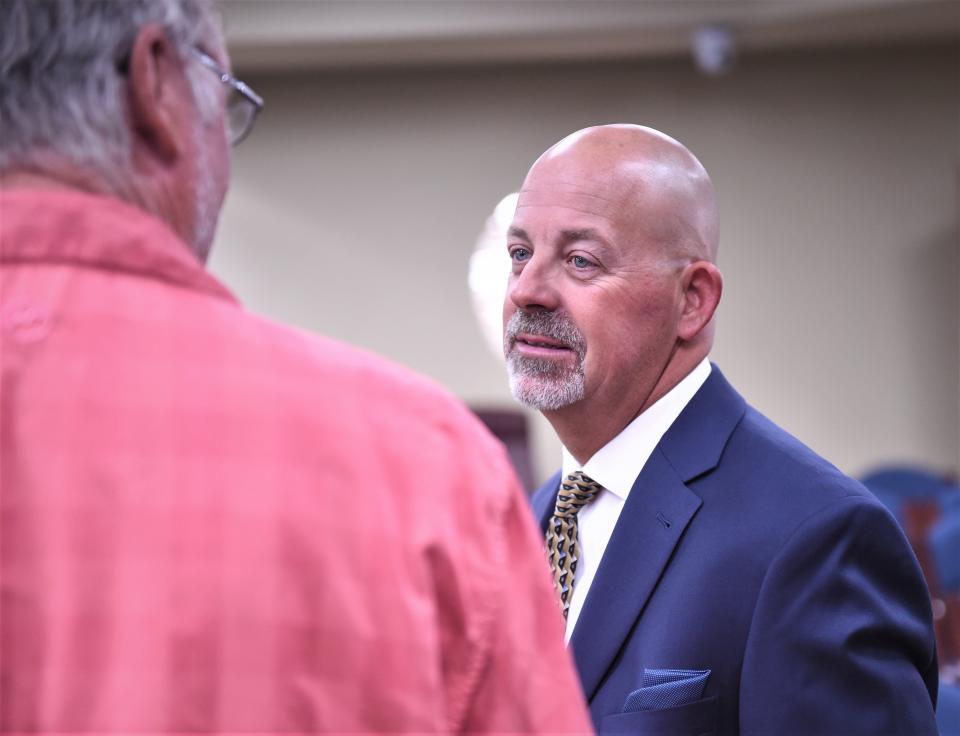 Brad Harman, right, talks an Abilene High fan after being introduced as the Eagles head baseball coach on Thursday, June 16, 2022, at the Abilene ISD board room.