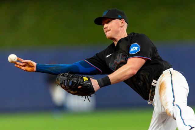 Miami Marlins first baseman Garrett Cooper (26) throws from the