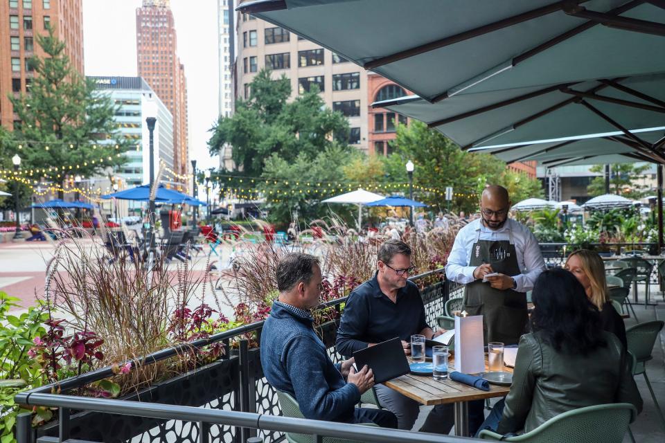 Don Brown, 56, of Beverly Hills, (right) and Eric Shreffler, 53, of Beverly Hills sit down for dinner with their wives at Leila restaurant in downtown Detroit on Sept. 29, 2023.