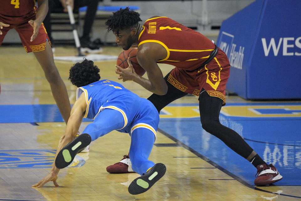 Southern California forward Chevez Goodwin, right, steals the ball from UCLA guard Jules Bernard during the first half of an NCAA college basketball game Saturday, March 6, 2021, in Los Angeles. (AP Photo/Mark J. Terrill)