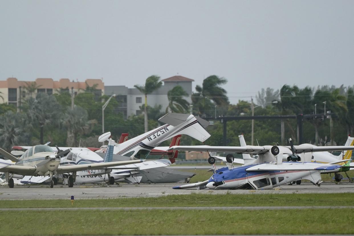 Airplanes overturned by a likely tornado produced by the outer bands of Hurricane Ian are shown, Wednesday, Sept. 28, 2022, at North Perry Airport in Pembroke Pines, Fla. Hurricane Ian rapidly intensified as it neared landfall along Florida's southwest coast Wednesday morning, gaining top winds of 155 mph (250 kph), just shy of the most dangerous Category 5 status.