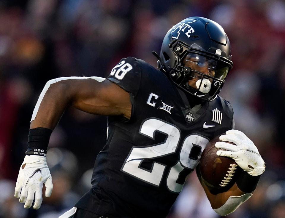 FILE - Iowa State running back Breece Hall (28) carries the ball upfield during an NCAA college football game against TCU, Nov. 26, 2021, in Ames, Iowa. Hall was voted to The Associated Press' All-Big 12 team, in voting released Thursday, Dec. 9. (AP Photo/Charlie Neibergall, File)