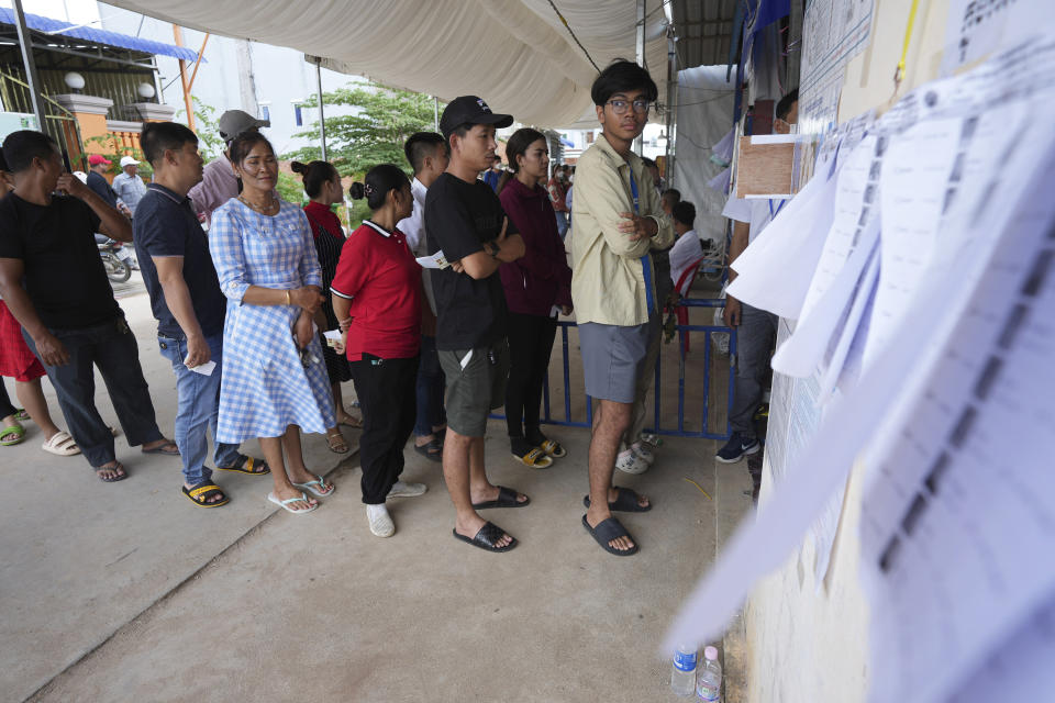Locals line up for voting at a polling station at Krang Thnung village outside Phnom Penh, Cambodia, Sunday, July 23, 2023. (AP Photo/Heng Sinith)