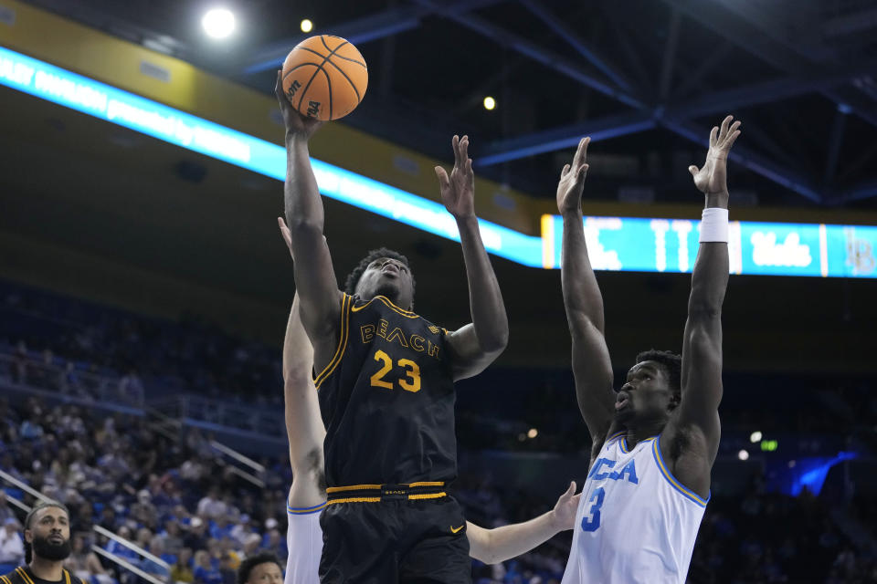 Long Beach State forward Lassina Traore (23) shoots next to UCLA forward Adem Bona (3) during the first half of an NCAA college basketball game Friday, Nov. 11, 2022, in Los Angeles. (AP Photo/Marcio Jose Sanchez)