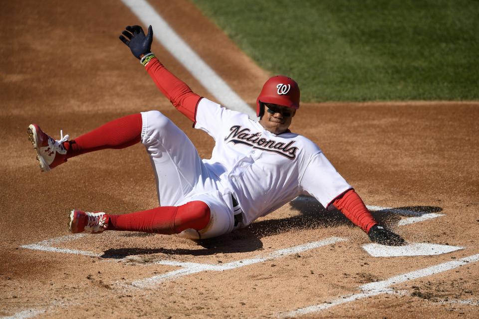 Washington Nationals' Juan Soto slides home to score on a single by Asdrubal Cabrera during the first inning of the first baseball game of a doubleheader against the Philadelphia Phillies, Tuesday, Sept. 22, 2020, in Washington. (AP Photo/Nick Wass)