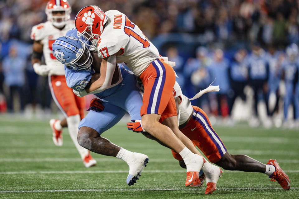 Clemson linebacker Wade Woodaz (17) tackles North Carolina tight end Kamari Morales (88) during the first half of the Atlantic Coast Conference championship NCAA college football game Saturday, Dec. 3, 2022, in Charlotte, N.C. (AP Photo/Jacob Kupferman)