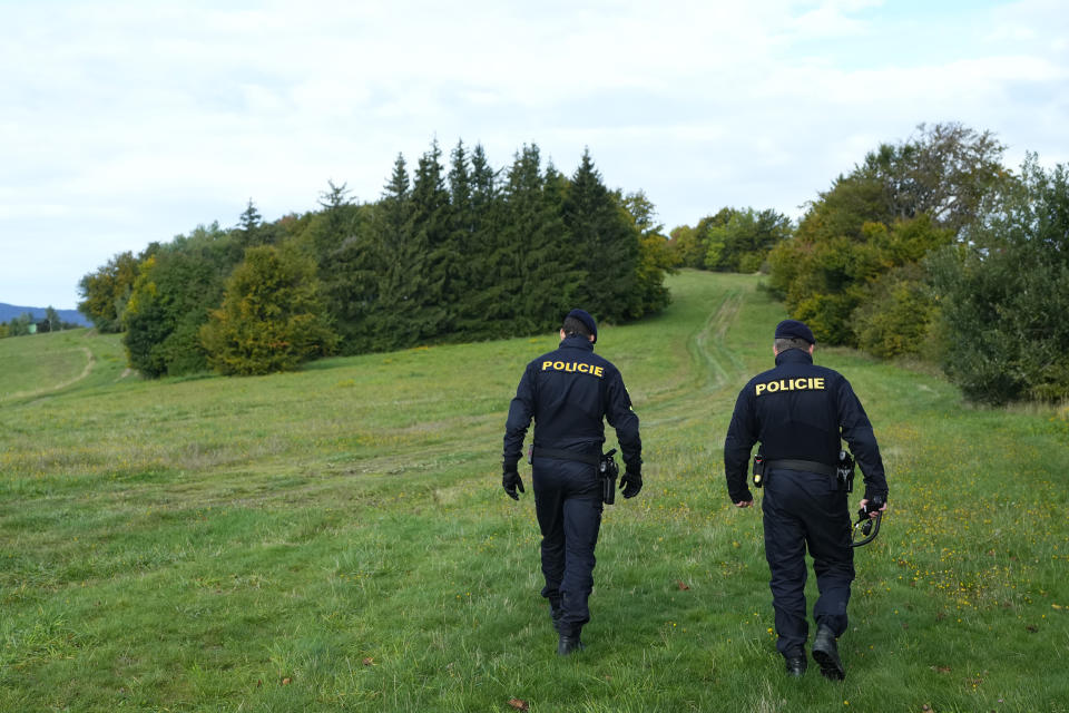 FILE - Czech policemen walk on patrol at the border with Slovakia near Stary Hrozenkov, Czech Republic, on Sept. 29, 2022. Slovakia will resume the checks at the border with Hungary to reduce the growing numbers of illegal migrants entering the country, the government decided on Wednesday Oct. 4, 2023. The measure, which will become effective on Thursday, came the day that the country’s neighbours, including Austria, the Czech Republic and Poland reintroduced controls on at their borders with Slovakia for at least 10 days to curb migration. (AP Photo/Petr David Josek, File)