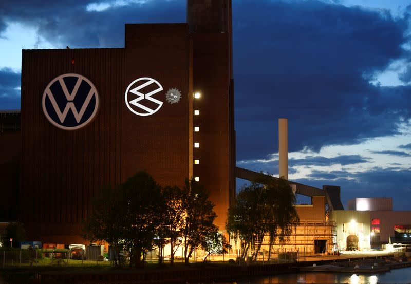 A cartoon of a VW logo squashing the coronavirus is displayed on a building at Volkswagen's headquarters to celebrate the plant's re-opening during the spread of the coronavirus disease (COVID-19) in Wolfsburg