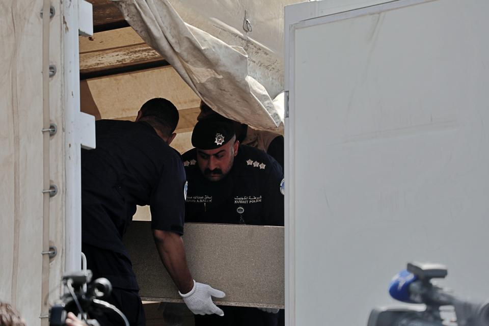 A casket holding the remains of one of 48 Kuwaiti citizens is transferred from an Iraqi truck to a Kuwaiti truck during a handover ceremony at the Safwan border crossing, in Iraq, Thursday, Aug. 8, 2019. Iraqi and Kuwaiti state media said Iraq has handed over to Kuwait the remains of 48 Kuwaitis who went missing during the 1991 Gulf War. (AP Photo)