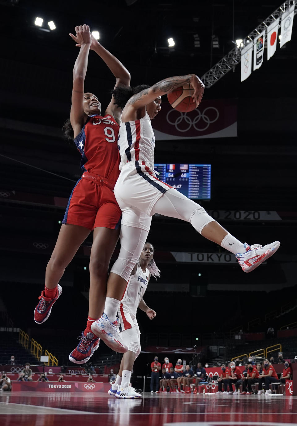 United States' A'Ja Wilson (9) and France's Endene Miyem (5) jump for a rebound during women's basketball preliminary round game at the 2020 Summer Olympics, Monday, Aug. 2, 2021, in Saitama, Japan. (AP Photo/Eric Gay)