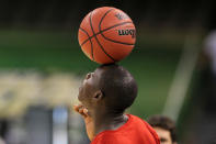 NEW ORLEANS, LA - MARCH 30: Gorgui Dieng #10 of the Louisville Cardinals balances a basketball on his head during practice prior to the 2012 Final Four of the NCAA Division I Men's Basketball Tournament at the Mercedes-Benz Superdome on March 30, 2012 in New Orleans, Louisiana. (Photo by Jeff Gross/Getty Images)