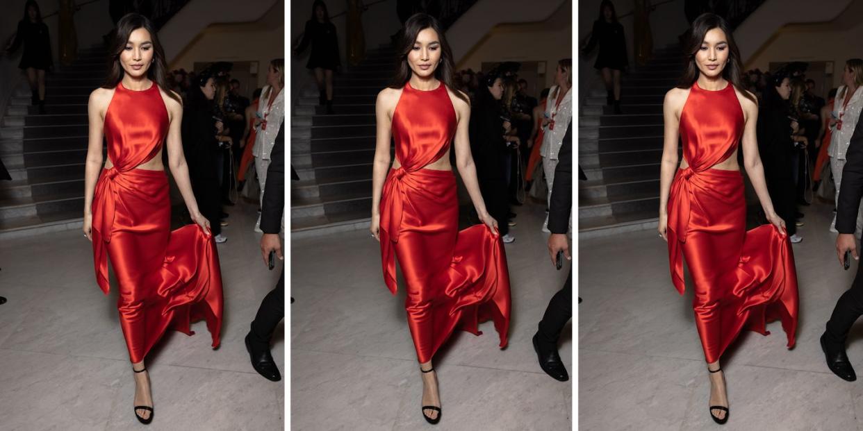 gemma chan wears a cutout satin dress to illustrate a guide to the best wedding guest rehearsal dresses