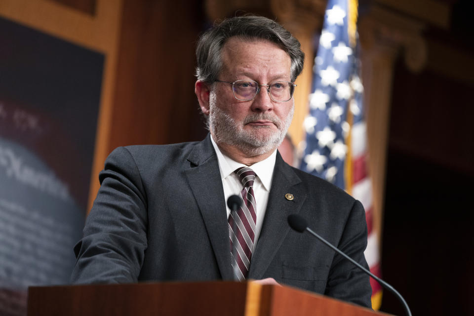 FILE - Sen. Gary Peters, D-Mich., listens to a question during a news conference on Capitol Hill, March 8, 2022, in Washington. President Joe Biden's increasingly stark warnings about Trump-fueled elements of the Republican Party are making up the core part of his midterm message, combined with repeated reminders to voters about recent Democratic accomplishments and a promise that democracy can still produce results for the American people. "It's a particularly strong issue for our base," said Peters, who leads the Democratic Senatorial Campaign Committee, the official campaign arm of Senate Democrats. (AP Photo/Evan Vucci, File)