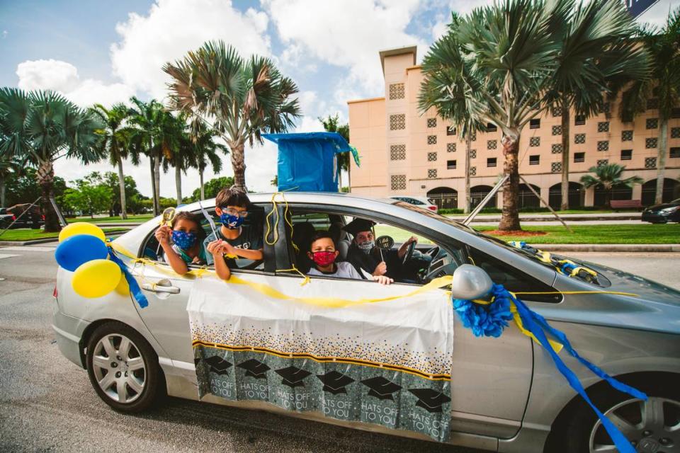 Students drive by a per-commencement caravan at Florida International University in 2020. In-person graduations resume for the Spring 2021 graduates on April 24, 2021.