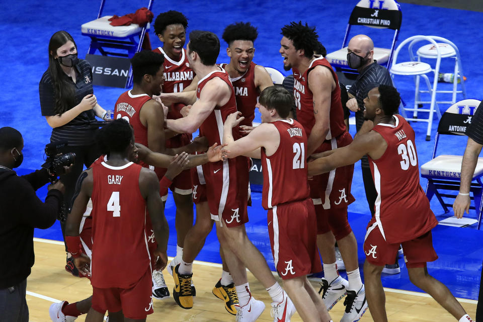 Alabama players celebrate after defeating Kentucky 85-65 in an NCAA college basketball game in Lexington, Ky., Tuesday, Jan. 12, 2021. (AP Photo/James Crisp)