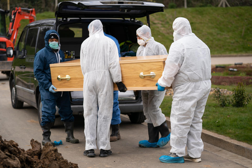 Undertakers in protective gear carry Ismail Mohamed Abdulwahab's coffin after he died of the coronavirus.