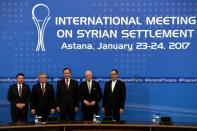 Russian, Turkish, Kazakh, Syrian, Iranian and UN counterparts pose after the announcement of a final statement following Syria peace talks in Astana on January 24, 2017