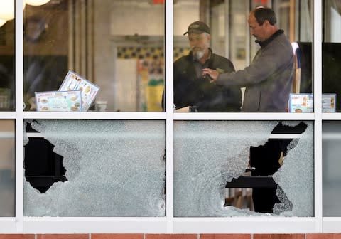 Shattered windows at the Waffle House restaurant - Credit: AP Photo/Mark Humphrey