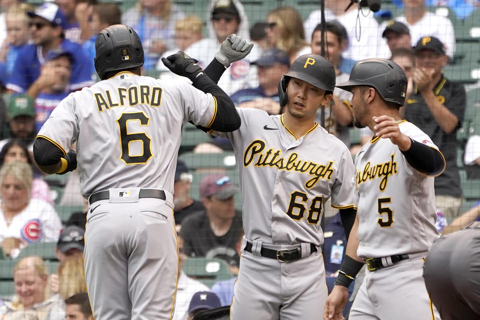 CORRECTS TO TWO-RUN HOME RUN, NOT A THREE-RUN - Pittsburgh Pirates' Anthony Alford (6) celebrates after his two-run home run off Chicago Cubs starting pitcher Alec Mills with Hoy Park (68) and Michael Perez during the sixth inning of a baseball game Friday, Sept. 3, 2021, in Chicago. (AP Photo/Charles Rex Arbogast)