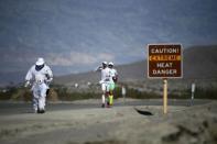 Competitors run in the Badwater Ultramarathon in Badwater Ultramarathon at the Death Valley National Park, California in this July 15, 2013 file photo. An ultramarathon involves a combination of running and walking further than the traditional marathon of 26.2 miles (42.2 kilometres). Though most ultras cover distances of either 50 or 100 miles, many are much longer. For the ultramarathoner, it is all about running for joy, setting personal goals and trying to overcome every obstacle faced. To match ATHLETICS-ULTRAMARATHONS/ REUTERS/Lucy Nicholson/Files (UNITED STATES - Tags: SPORT ATHLETICS)