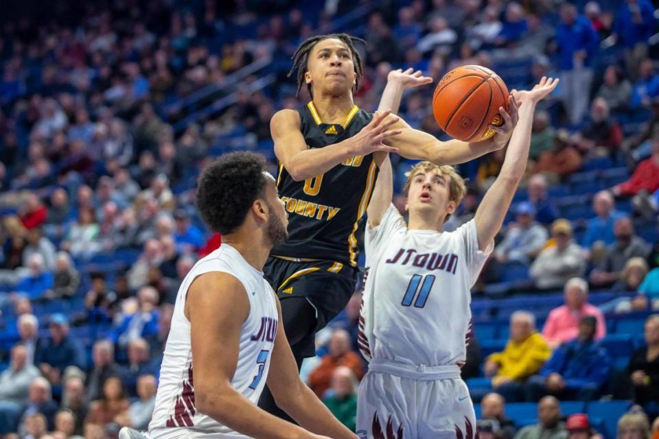 Santonio Waide (0) drives between Jeffersontown’s Lukus McDaniels (3) and Rhys Taylor (11) on Wednesday. Waide led Woodford County with 15 points and also contributed four rebounds, four assists and two steals.