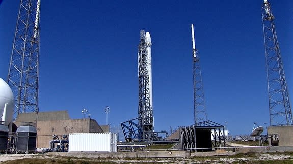 A SpaceX Falcon 9 rocket and Dragon cargo ship stand atop its Florida launch pad ahead of a planned April 14, 2014 launch to the International Space Station. The mission for NASA will launch from Cape Canaveral Air Force Station.