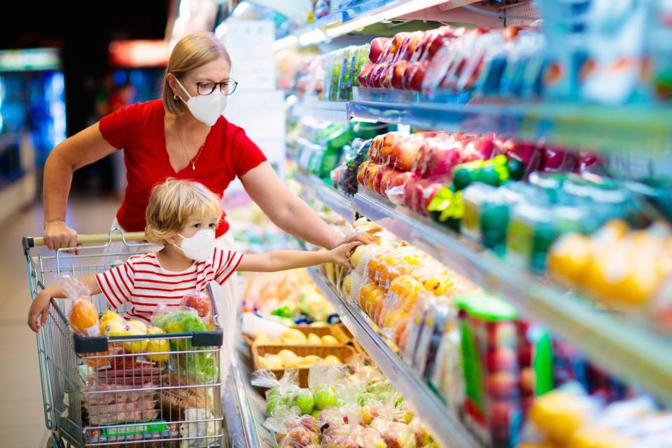 Woman and child grocery shopping.