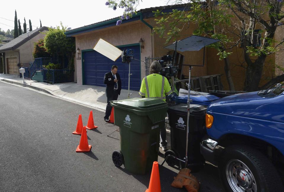 Media wait outside the home of director Peter Rodger in Woodland Hills, California