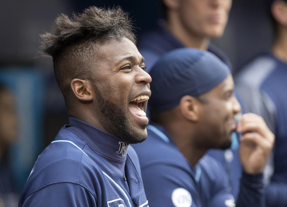 Tampa Bay Rays' Guillermo Heredia laughs in the dugout during a baseball game against the Toronto Blue Jays in Toronto, Sunday, Sept. 29, 2019. (Fred Thornhill/The Canadian Press via AP)