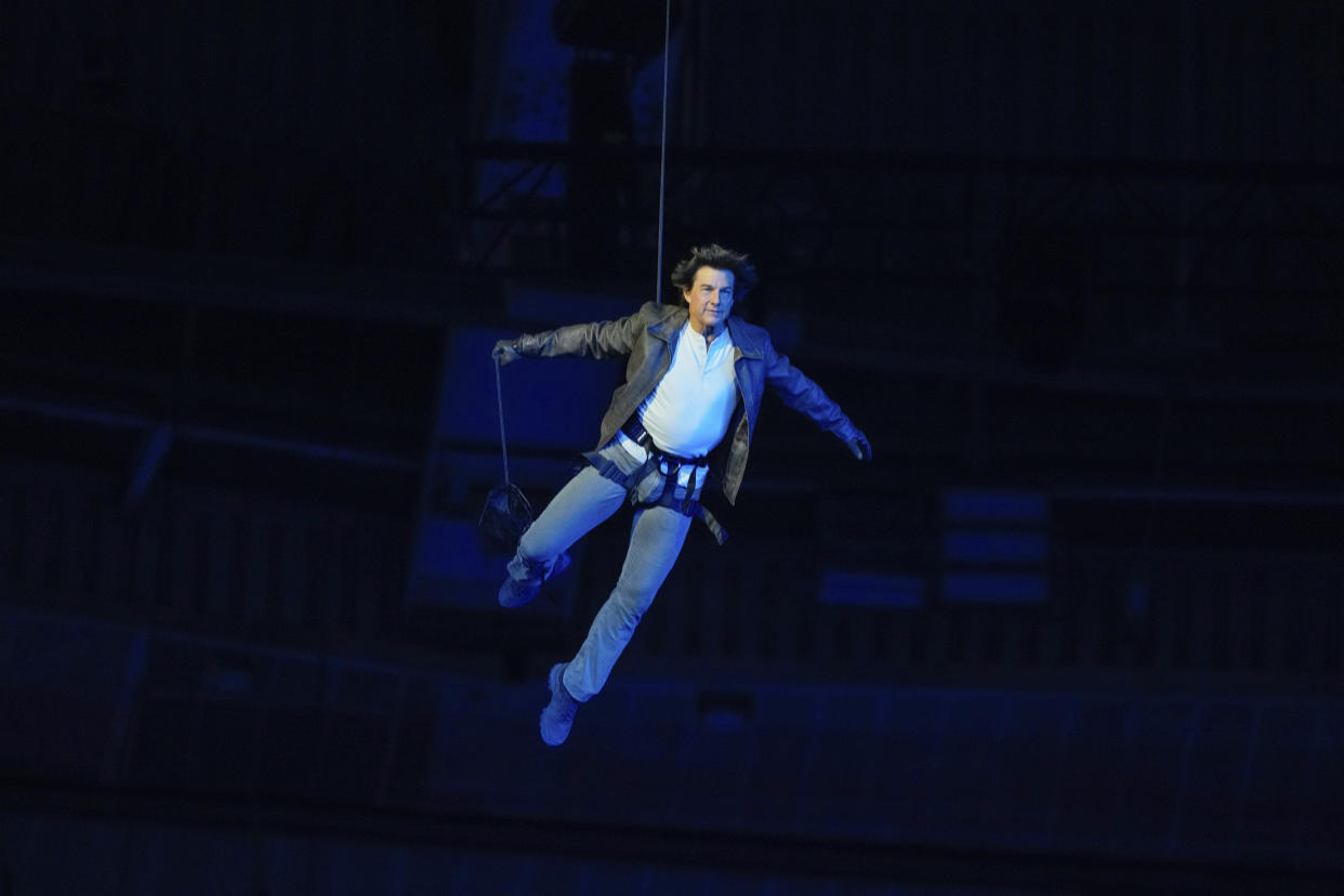 Tom Cruise is lowered into the Stade de France during the Olympics closing ceremony on Aug. 11.