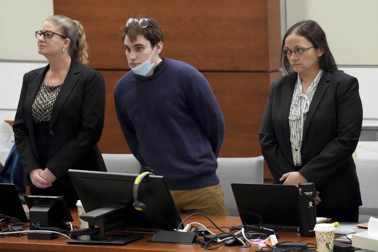 Marjory Stoneman Douglas High School shooter Nikolas Cruz, center, stands with members of his defense team as jurors enter the courtroom during the penalty phase of Cruz's trial at the Broward County Courthouse in Fort Lauderdale, Fla., on Thursday, Oct. 6, 2022.