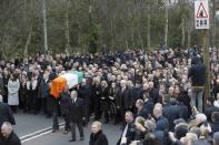 The coffin of Martin McGuinness is carried through crowded streets during his funeral in Londonderry, Northern Ireland, March 23, 2017. REUTERS/Phil Noble