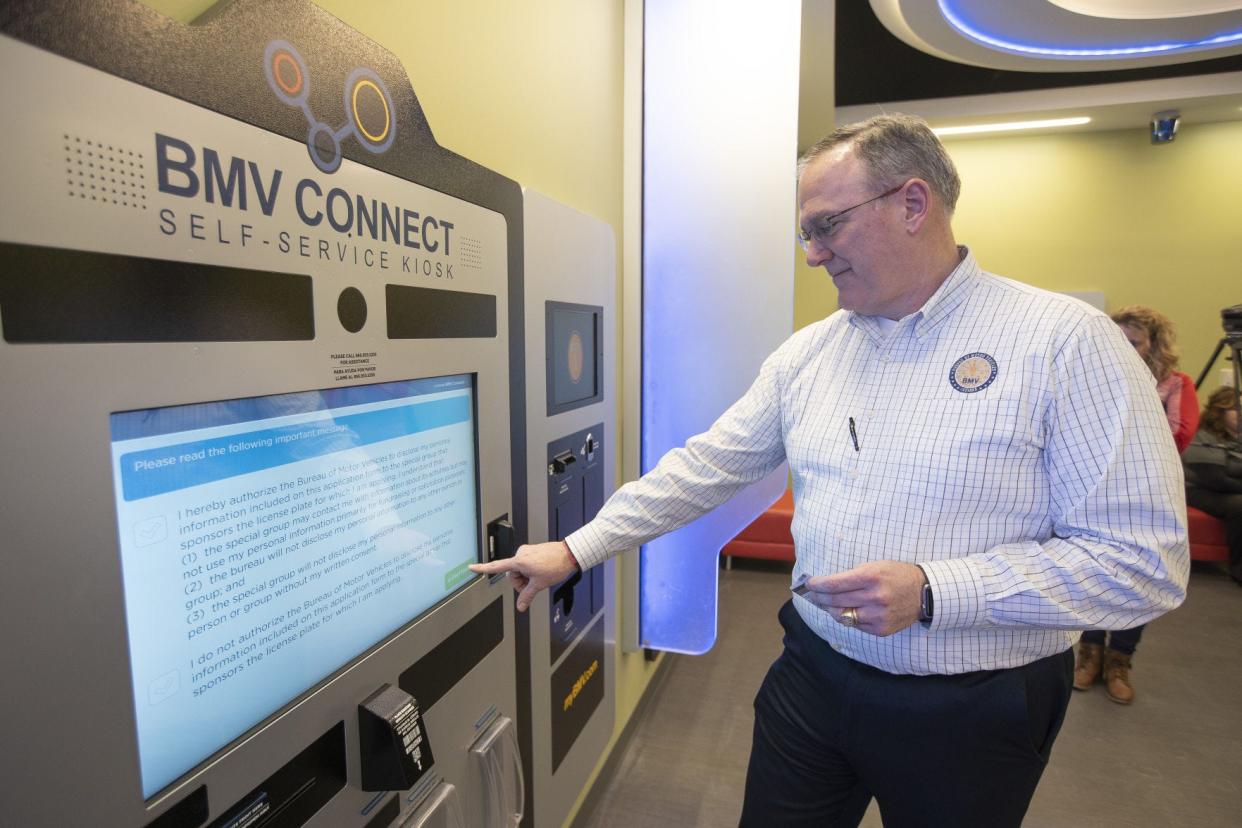 Indiana Bureau of Motor Vehicles Commissioner Peter Lacy demonstrates how to use one of the BMV Connect kiosks at the Mishawaka branch.