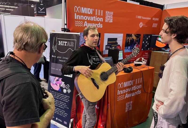 Andrea Martelloni demonstrates the 'HITar', an AI-powered augmented guitar at the 2024 National Association of Music Merchants (NAMM) trade show in Anaheim