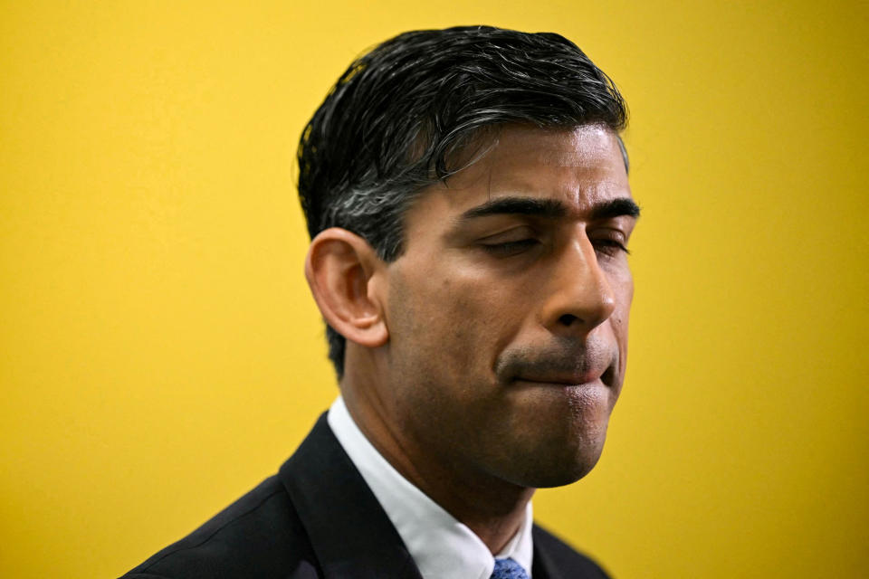 FILE PHOTO: Britain's Prime Minister Rishi Sunak reacts as he speaks to journalists during a visit of a medical training centre at the University of Surrey in Guildford, southern England, on November 30, 2023.     JUSTIN TALLIS/Pool via REUTERS/File Photo