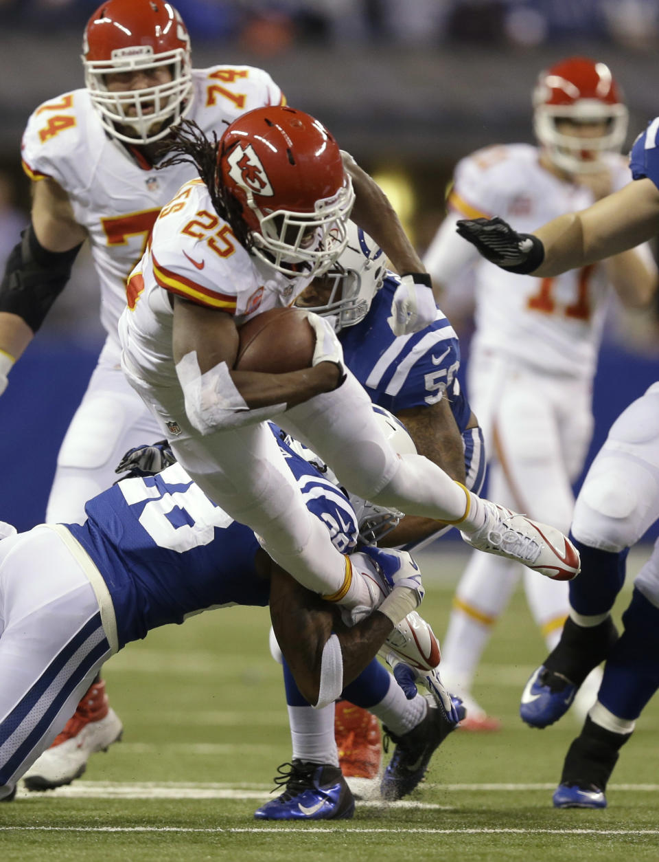 Indianapolis Colts cornerback Greg Toler (28) tackles Kansas City Chiefs running back Jamaal Charles (25) during the first half of an NFL wild-card playoff football game Saturday, Jan. 4, 2014, in Indianapolis. (AP Photo/Michael Conroy)