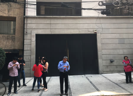 People stand outside a building after an earthquake in Mexico City, Mexico April 22, 2019. REUTERS/Carlos Jasso