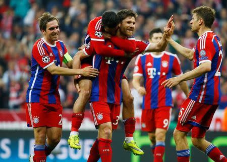 Bayern Munich's Xabi Alonso celebrates scoring their sixth goal with Thiago Alcantara, Philipp Lahm (L) and Thomas Muller (R). Reuters / Kai Pfaffenbach