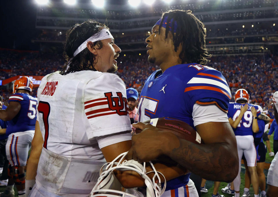 Sep 3, 2022; Gainesville, Florida, USA; Utah Utes quarterback Cameron Rising (7) and Florida Gators quarterback Anthony Richardson (15) meet after a game at Steve Spurrier-Florida Field. Mandatory Credit: Kim Klement-USA TODAY Sports