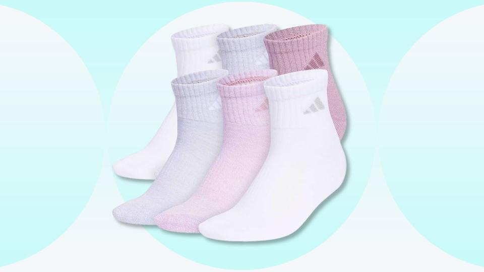 Pack of pink, gray and white adidas songs on a blue background. 