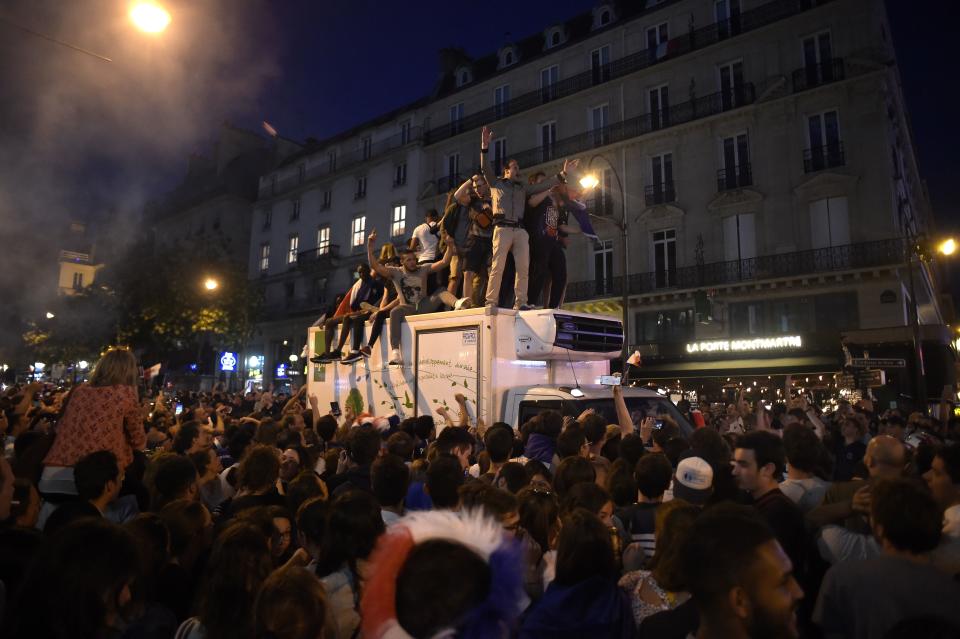 <p>People celebrate France’s victory in central Paris on July 10, 2018 after the final whistle of the Russia 2018 World Cup semi-final football match between France and Belgium. (Photo by Lucas BARIOULET / AFP) </p>