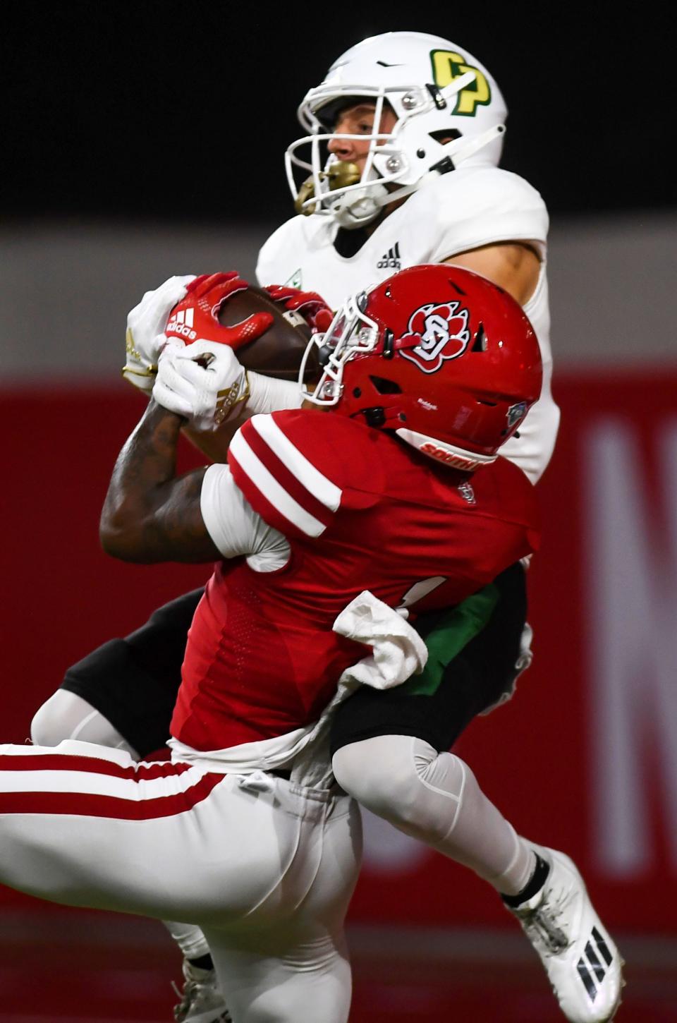 Cal Poly’s Logan Booher and South Dakota’s Myles Harden both grab the football from the air in the end zone Sept. 17, 2022, in Vermillion, South Dakota.