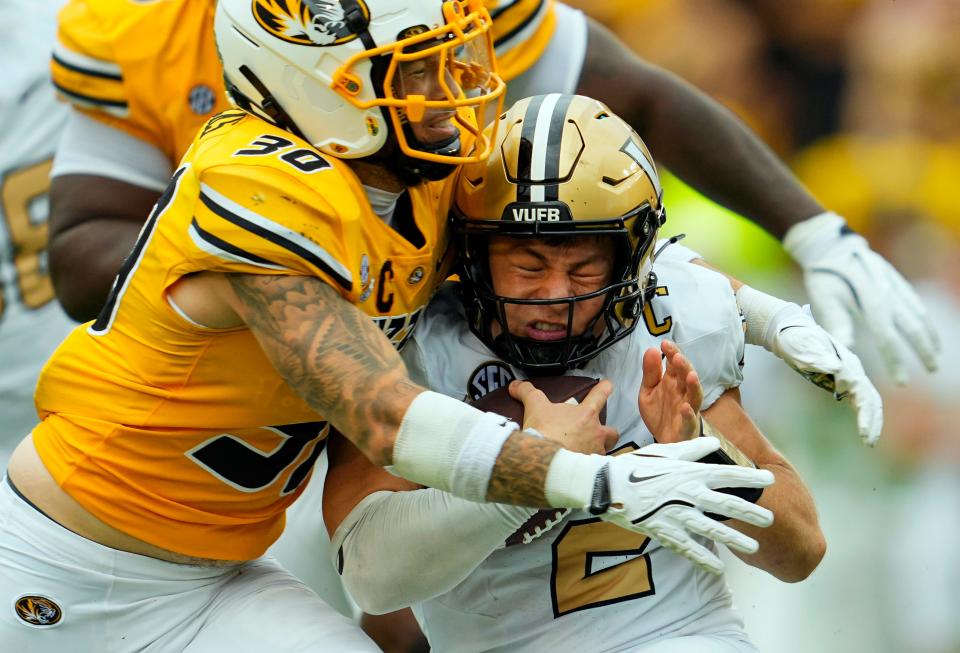 Vanderbilt quarterback Diego Pavia is sacked by Missouri linebacker Chuck Hicks.