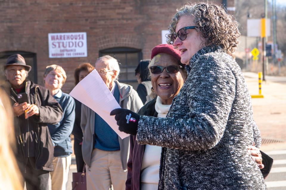 Catherine Mitchell, left, stands with Vic Isley, President and CEO of Explore Asheville, during the unveiling of the Asheville Black Cultural Heritage Trail in the River Arts District, December 15, 2023.